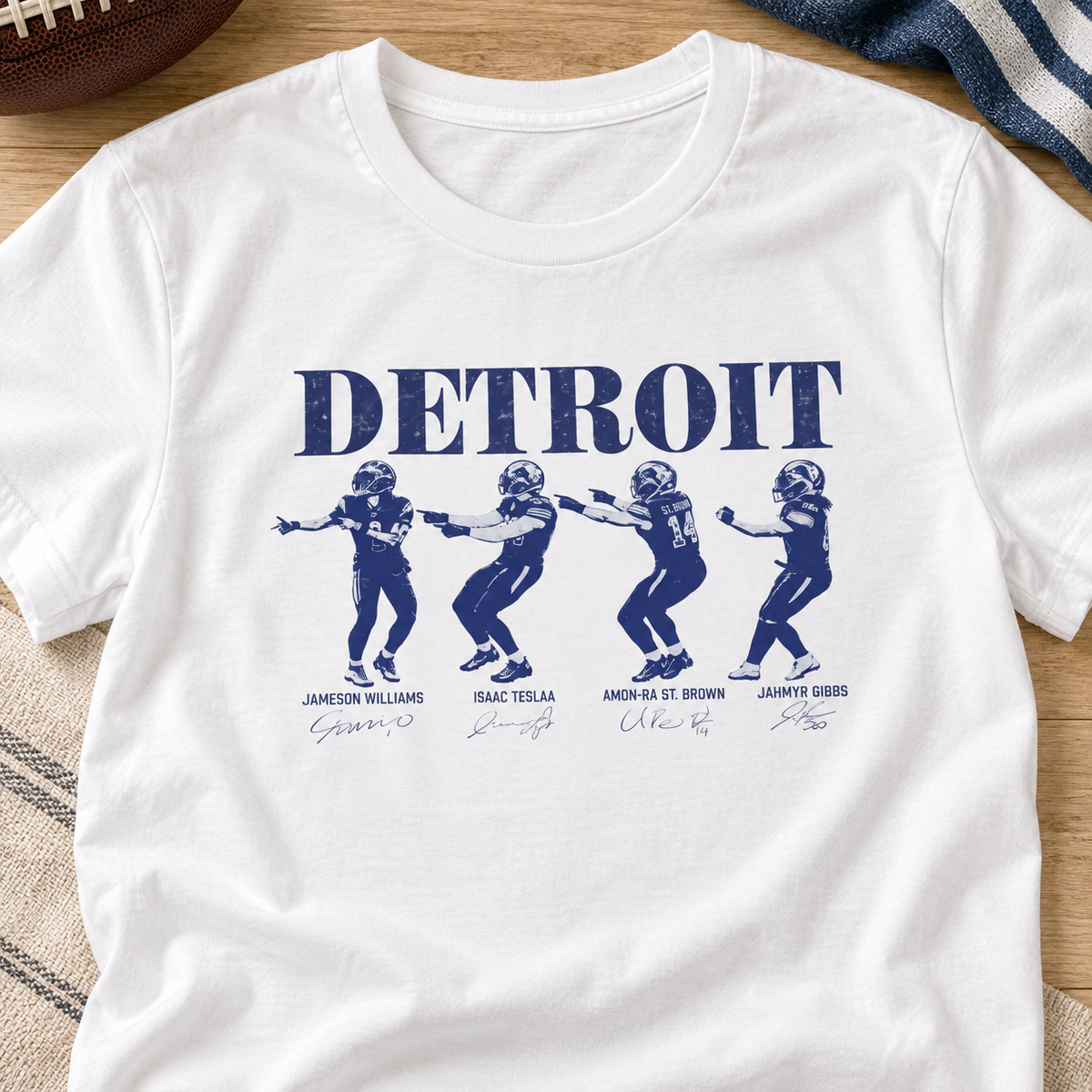 Detroit Lions Charlie Brown celebration shirt with four players, close-up white T-shirt layflat.