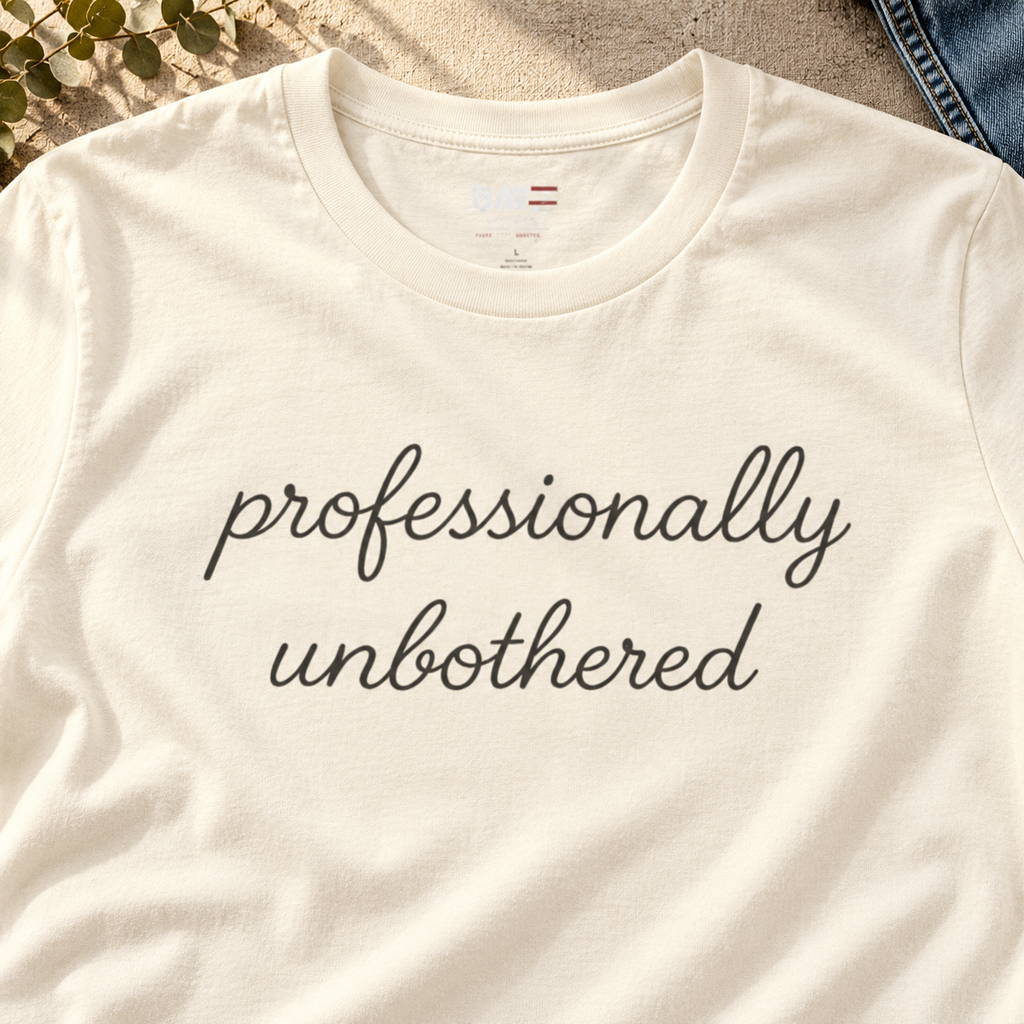 Professionally Unbothered Shirt | Sarcastic Graphic Tee — close-up lifestyle flat lay