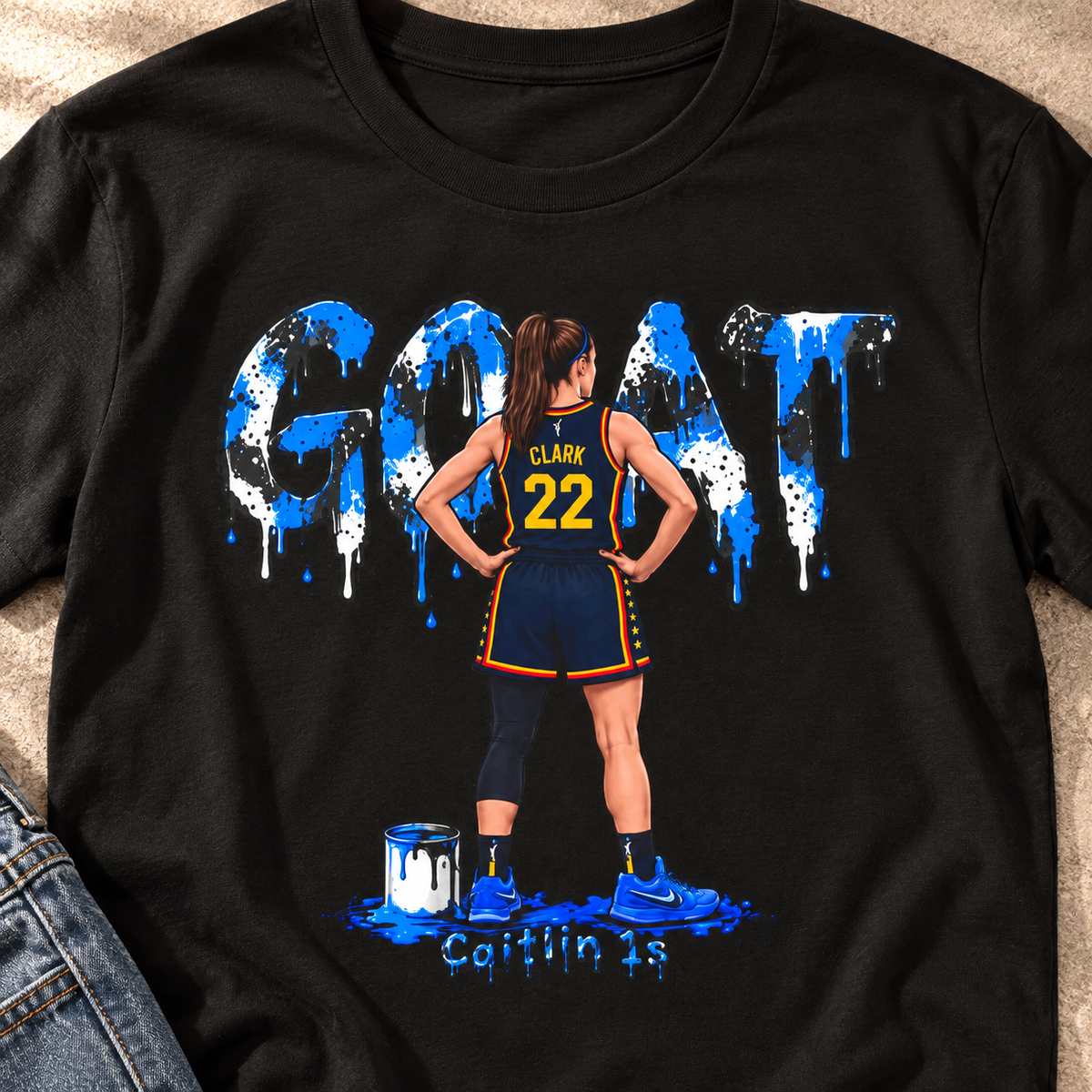 Indiana Fever – Caitlin Clark – Caitlin 1s GOAT Blue Paint Sneaker T-Shirt — close-up lifestyle flat lay