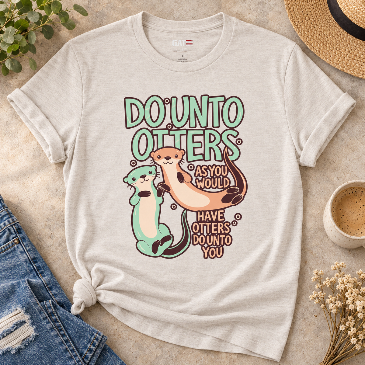Do Unto Otters Shirt | Cute Otter Kindness Graphic Tee — close-up lifestyle flat lay