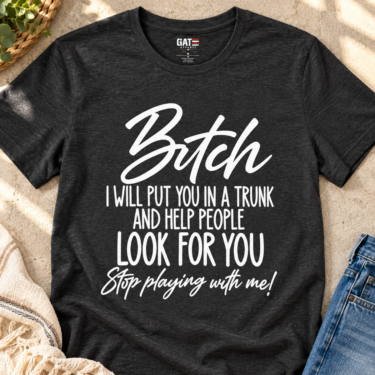 Funny 'Bitch I Will Put You in a Trunk' Graphic Tee — Sassy Statement Shirt — close-up lifestyle flat lay