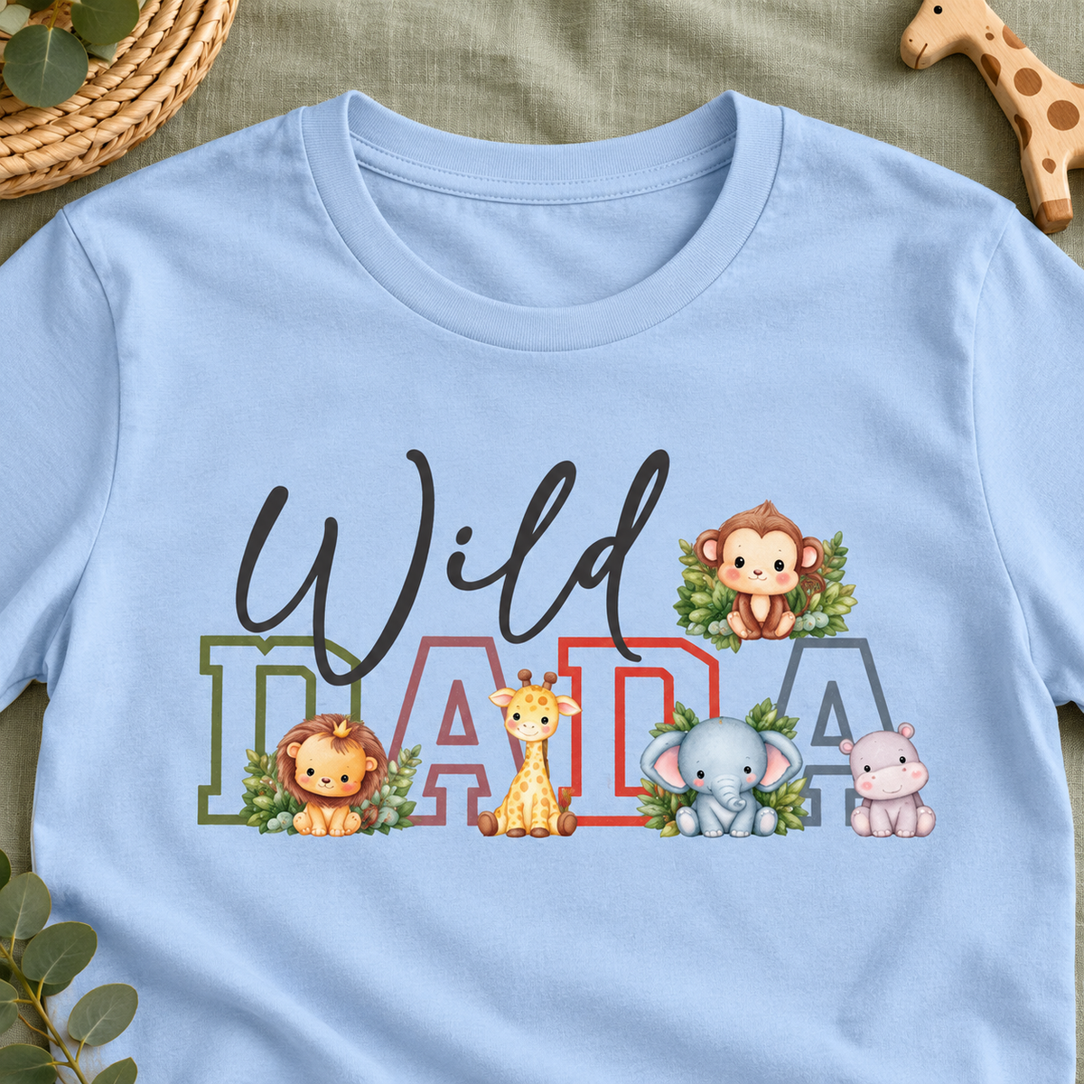 Wild Dada Safari Animals Tee – Cute Jungle Baby Animal Graphic Shirt — close-up lifestyle flat lay