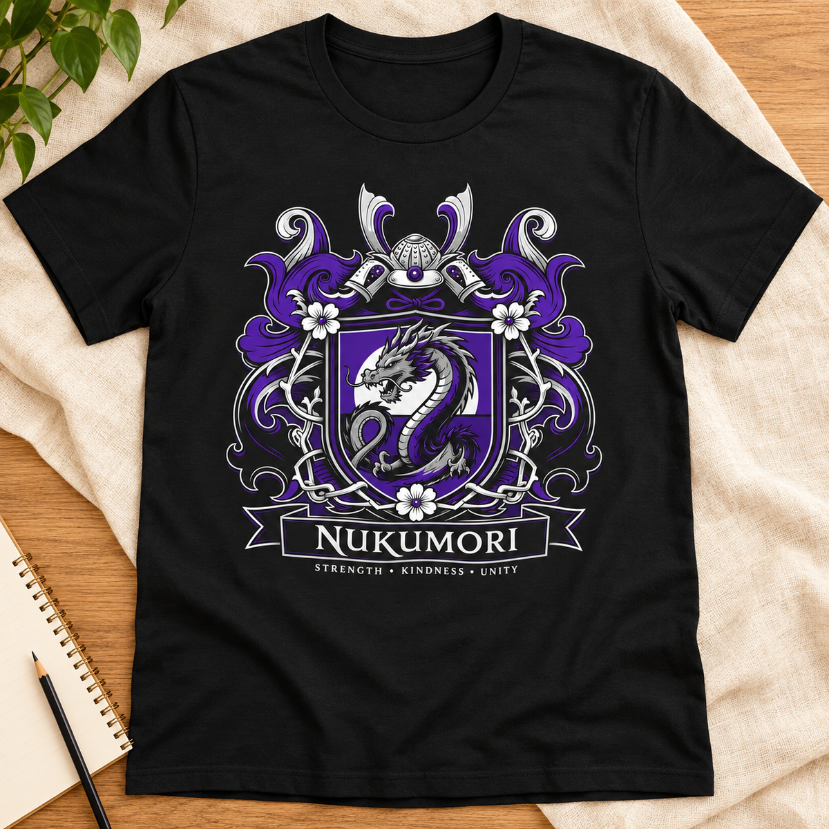 Ron Clark Nukumori Shield T-Shirt — layflat lifestyle mockup
