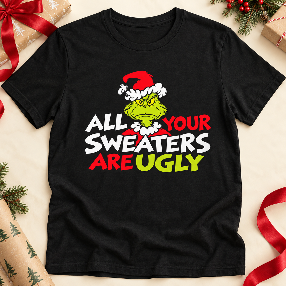 Grinch 'All Your Sweaters Are Ugly' Christmas Tee — zoomed-in lifestyle flat lay