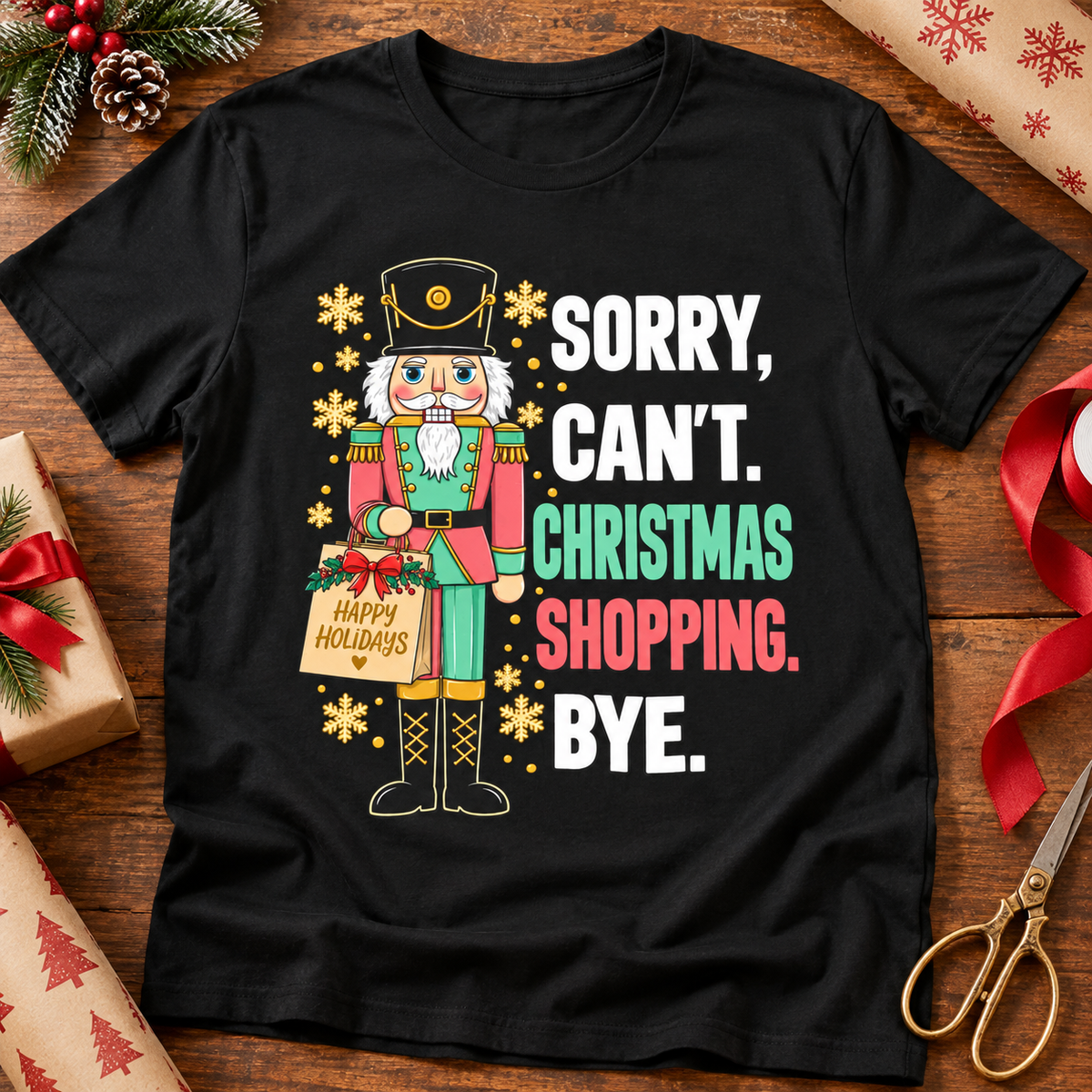 Sorry, Can’t. Christmas Shopping Bye. Graphic Tee — zoomed-in lifestyle flat lay