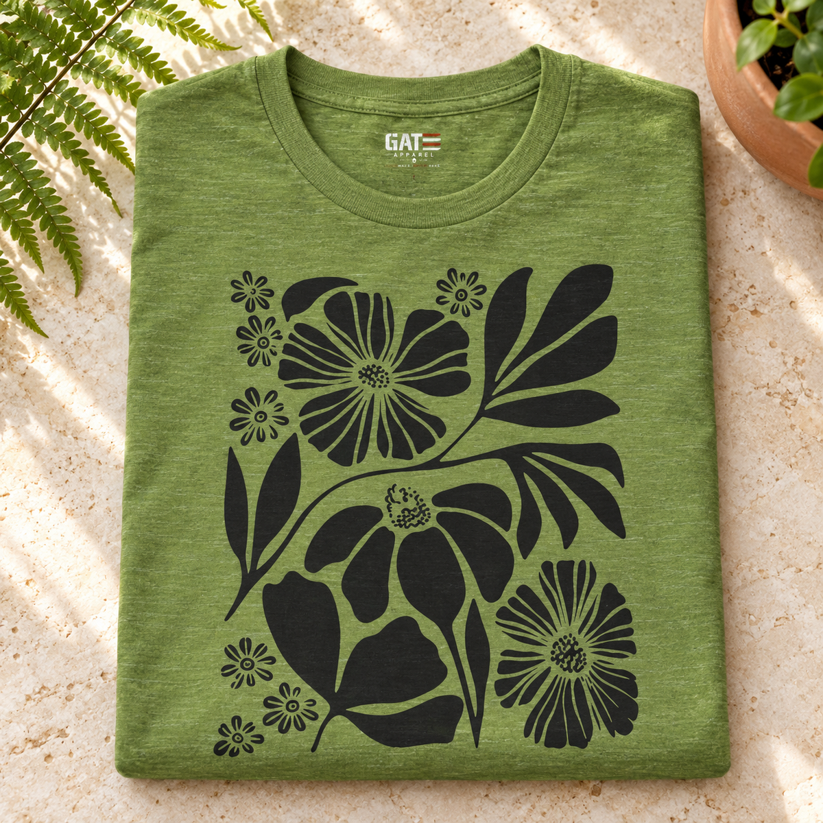 Black Floral Silhouette Shirt | Botanical Graphic Tee — folded shirt lifestyle mockup