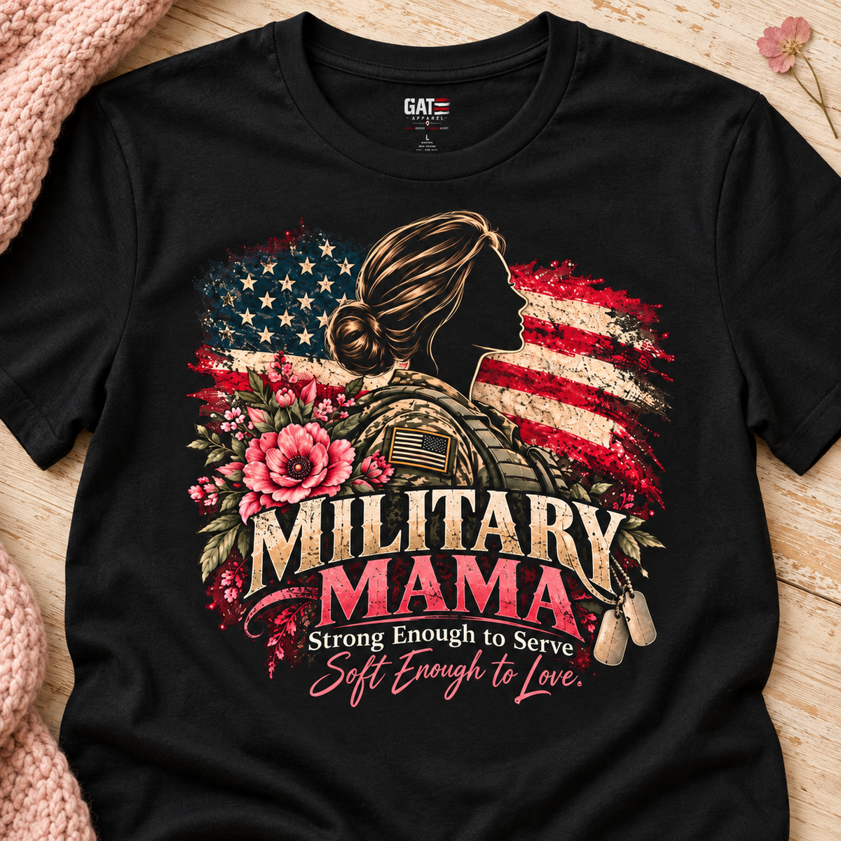 Military Mama Tee — Patriotic Mom Shirt with American Flag & Floral Combat Design — close-up lifestyle flat lay