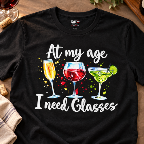 At My Age I Need Glasses Wine Lover T-Shirt — close-up lifestyle flat lay