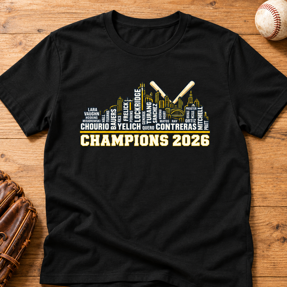 Black Milwaukee Brewers Champions 2026 player-name skyline T-shirt laid flat on a wood tabletop with a baseball and glove.